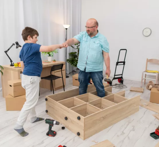 Father and son assembling furniture